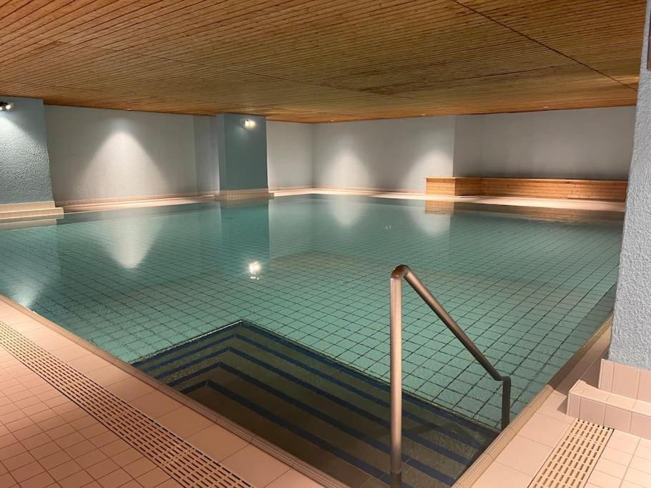圣莫里茨Ferienapartment in Bestlage in Sankt Moritz的大楼内一个带斜坡的大型游泳池