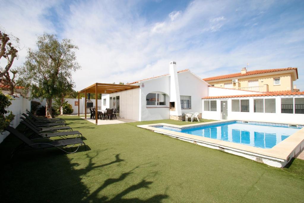 迈阿密普拉特亚Villa Atenea的一个带游泳池和房子的后院