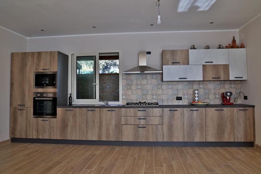 切法卢Villa Valentina的一个带木制橱柜和电器的大厨房