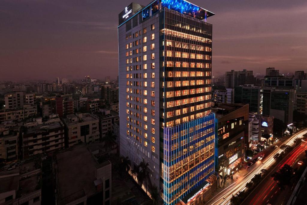 达卡Renaissance Dhaka Gulshan Hotel的一座高大的建筑,城市里灯火通明