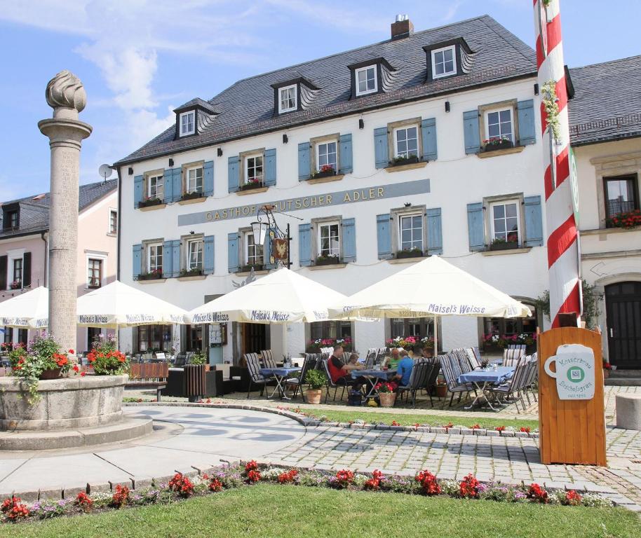 比绍夫斯格林普切勒-盖瑟霍夫德意志阿德勒饭店的大楼前设有桌椅的酒店