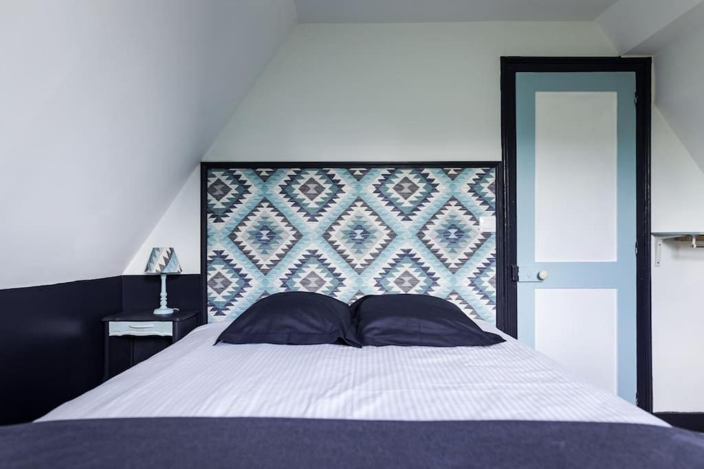 弗尔黎祖La Villa de l'Etoile 10 personnes的一间卧室配有一张大床和大床头板