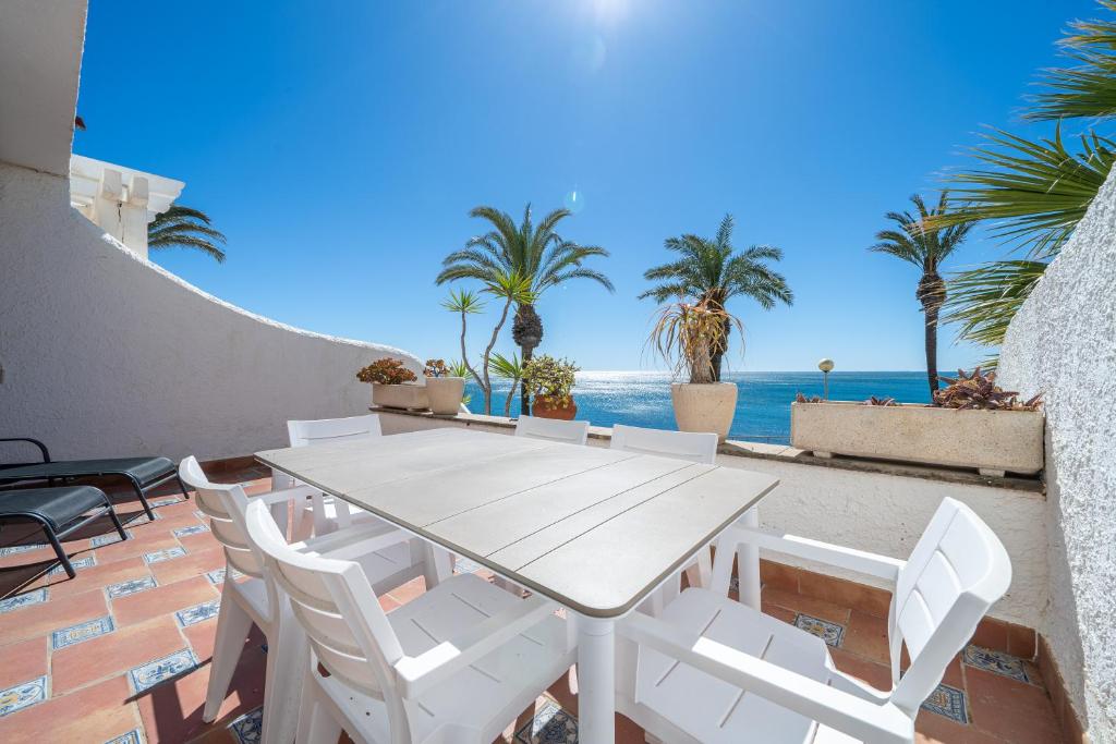 拉梅特拉·德·玛尔Hauzify I Casa Mirador的海景露台上的白色桌椅