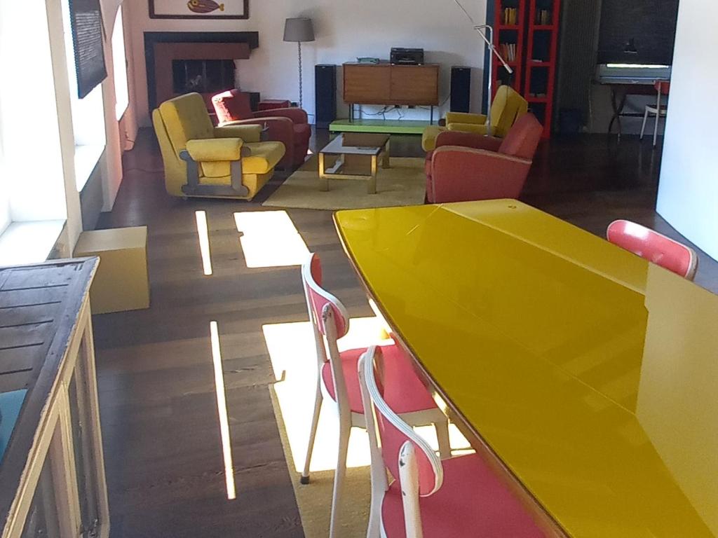 阿格诺La casa di Arnaldo "Punarinta"的客厅里一张黄色的桌子和椅子