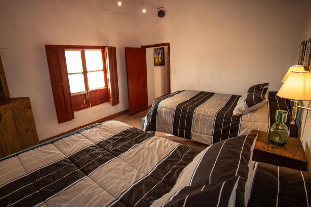 Cabaña Corazon de Calixto的酒店客房设有两张床和窗户。
