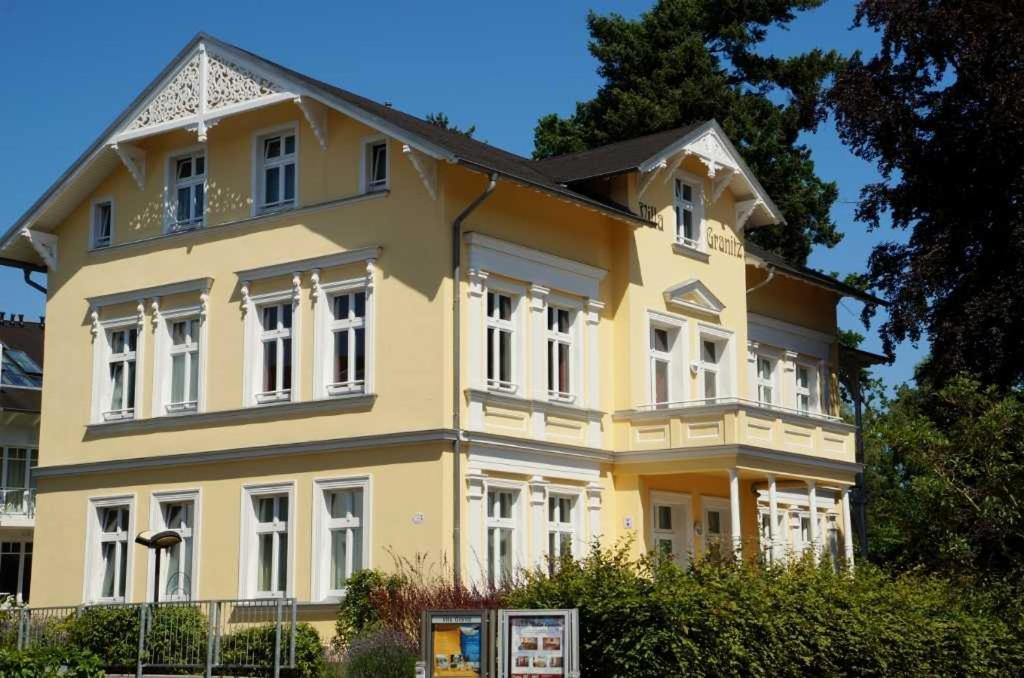 奥斯特巴德·哥伦Villa Granitz - Ferienwohnung 45466 (Sassnitz)的大型黄色房屋,设有白色窗户