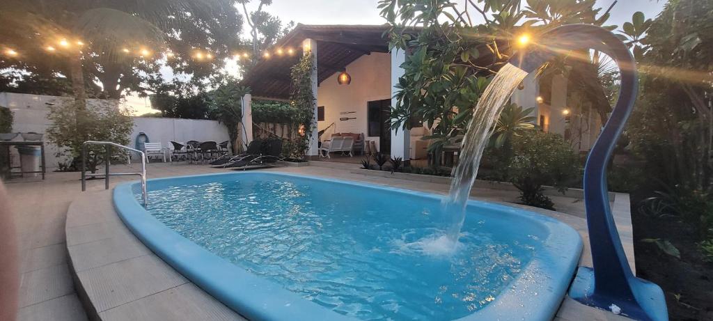 帕里普埃拉Casa Paraiso de Sonho Verde的庭院中一个带喷泉的游泳池