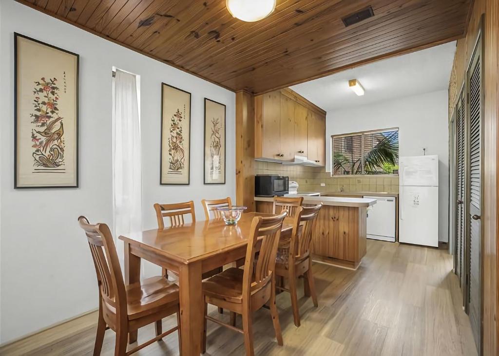 萨维特尔Banksia的厨房以及带木桌和椅子的用餐室。
