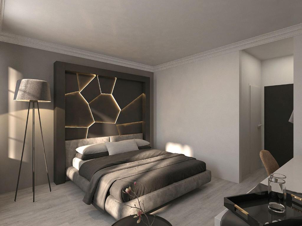 克桑滕DORMERO Hotel Xanten的一间卧室配有一张带黑色床头板的床