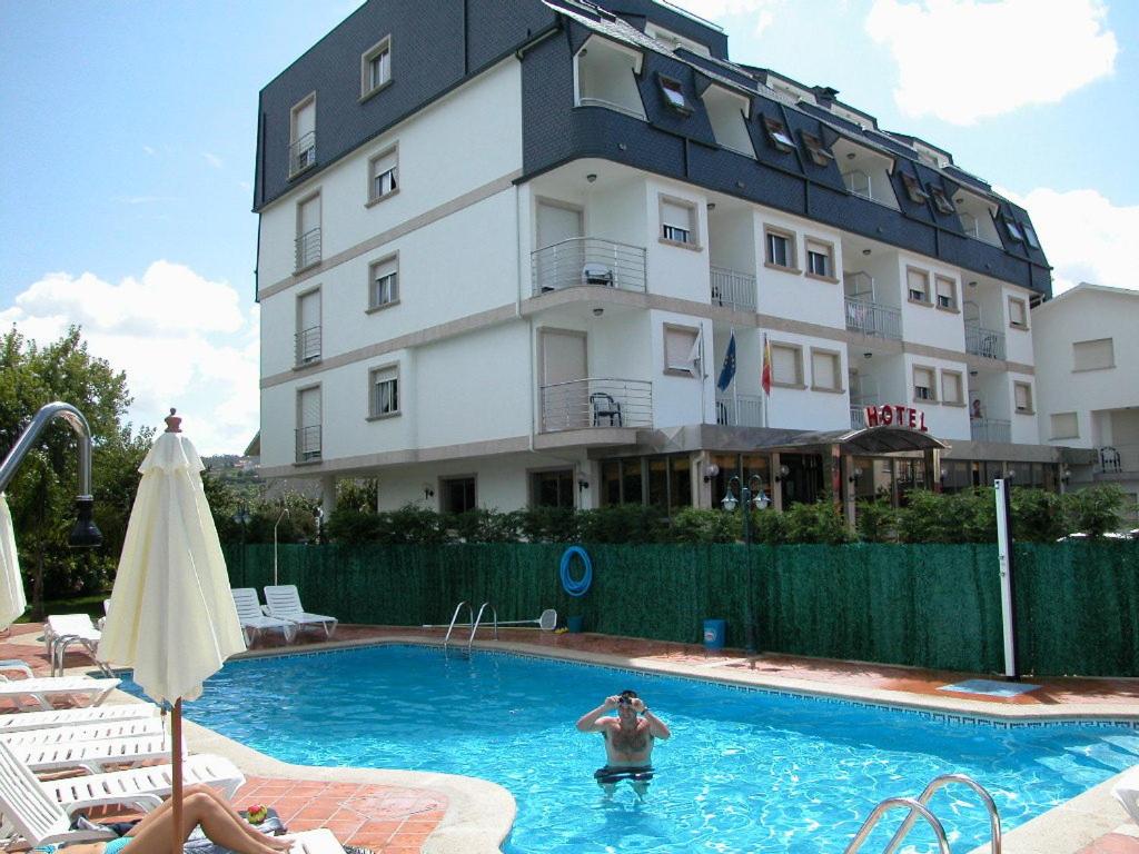 阿兰扎达Hotel Piñeiro 2 Estrellas Superior的建筑物前游泳池里的人