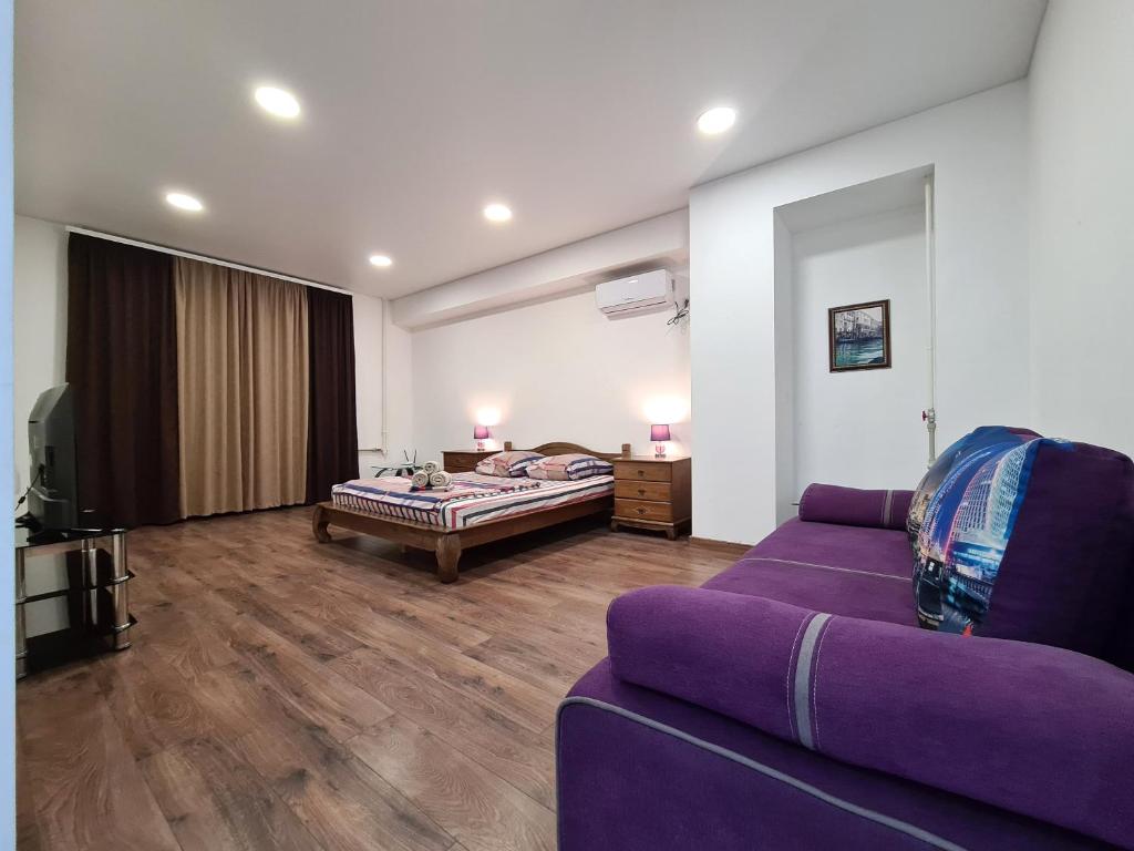 扎波罗热2-room Luxury Apartment on Sobornyi Avenue 192, by GrandHome的客厅配有紫色沙发和床。