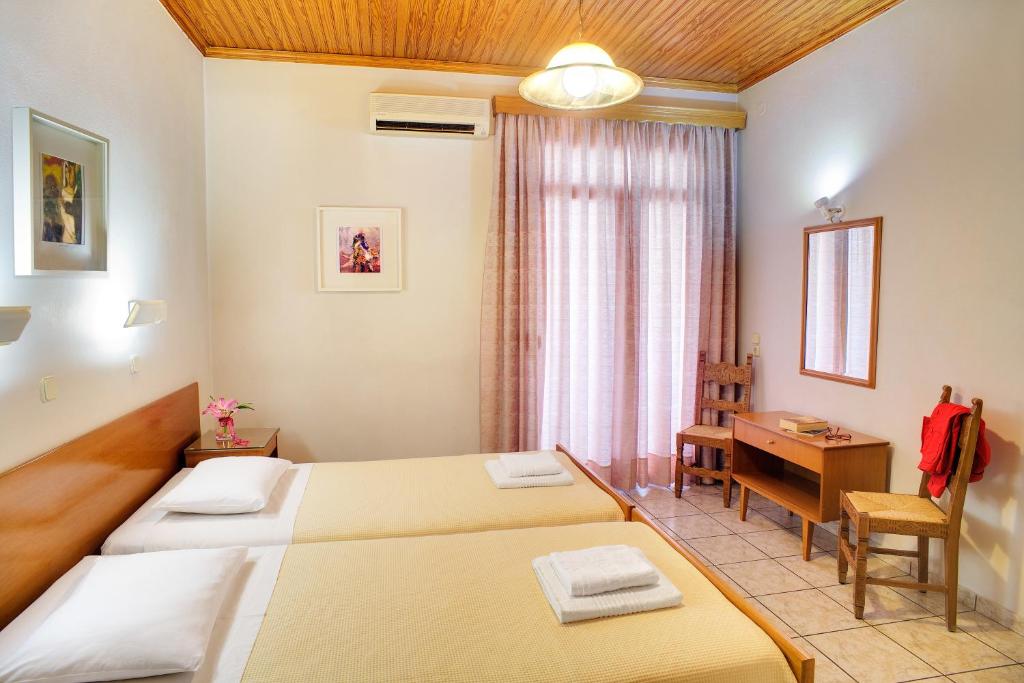 约阿尼纳迪奥尼酒店的酒店客房配有两张床和一张书桌
