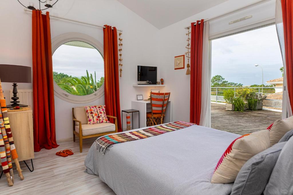 比斯卡罗斯海滩Côte et Dune的一间卧室设有一张床和一个大窗户