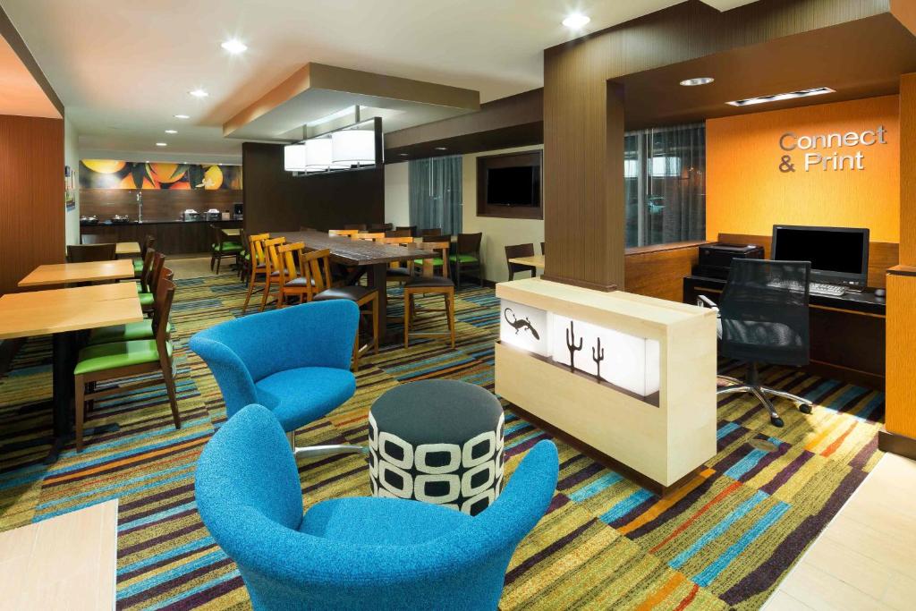 圣安东尼奥圣安东尼奥机场/北极星购物中心费尔菲尔德万豪套房酒店的大堂设有蓝色椅子和用餐室