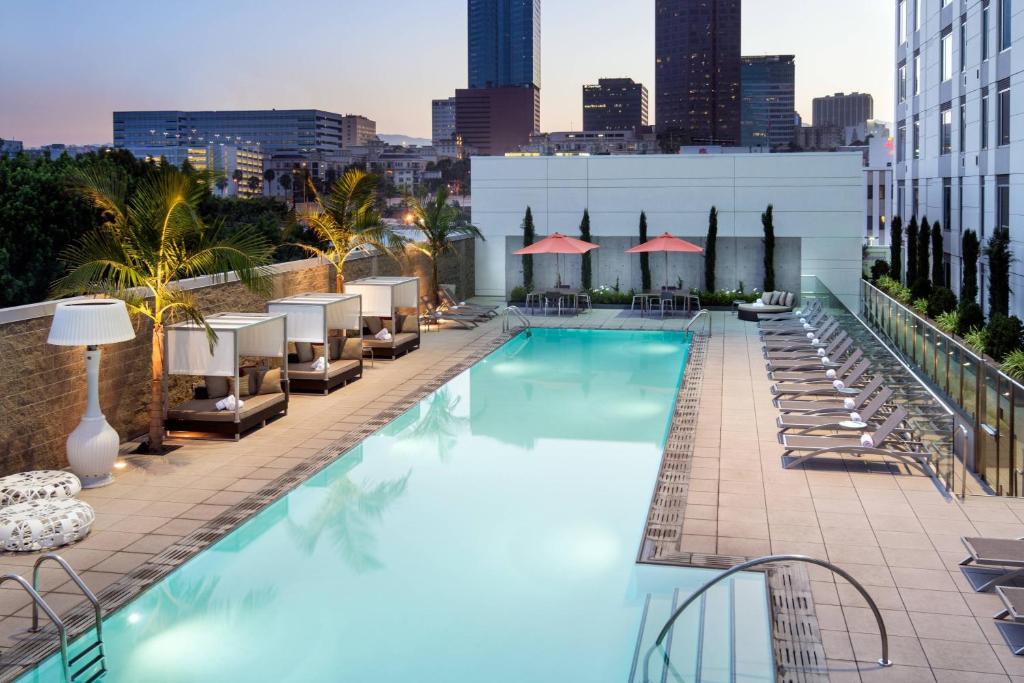 洛杉矶洛杉矶万豪L.A. LIVE中心原住客栈的一座位于酒店屋顶的游泳池,设有椅子和一座城市