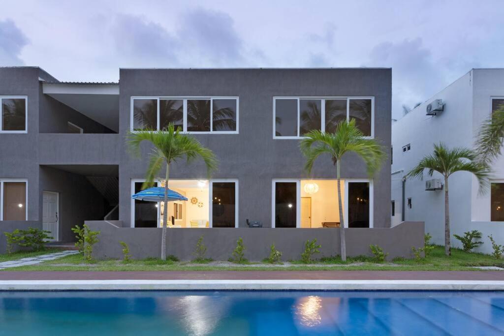 El ZapoteBeach front Blue Summer Apartment Costa Del Sol的房屋前有游泳池的房子