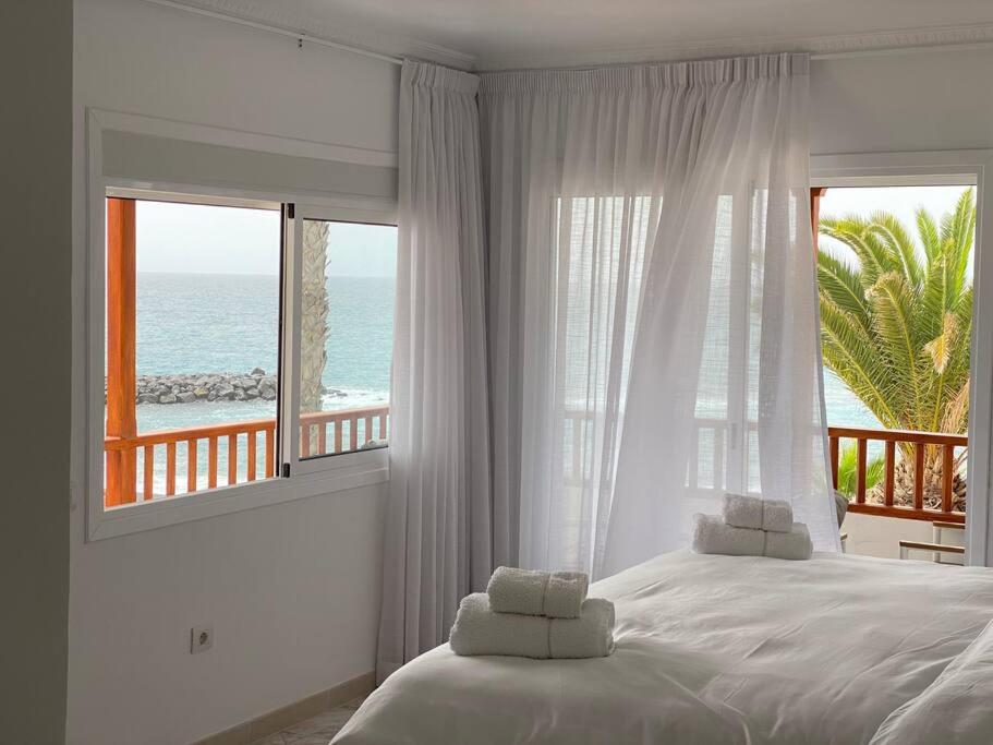 阿德耶Villa Tranquila, Playa del Duque的一间卧室设有一张床,享有海景