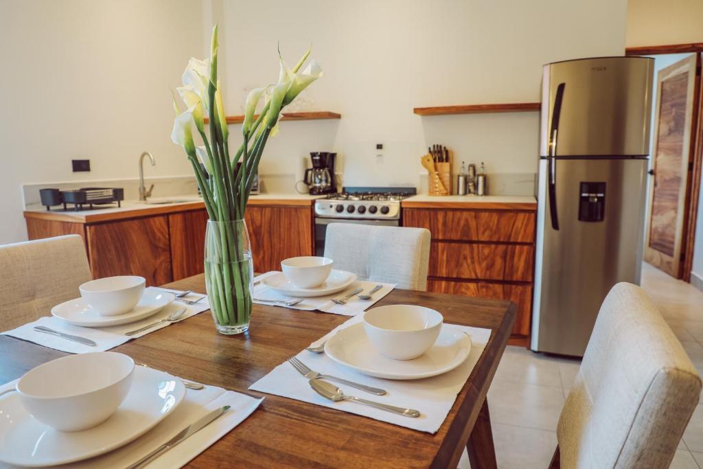 帕纳哈切尔Lahos Apartament B的厨房配有木桌、椅子和冰箱