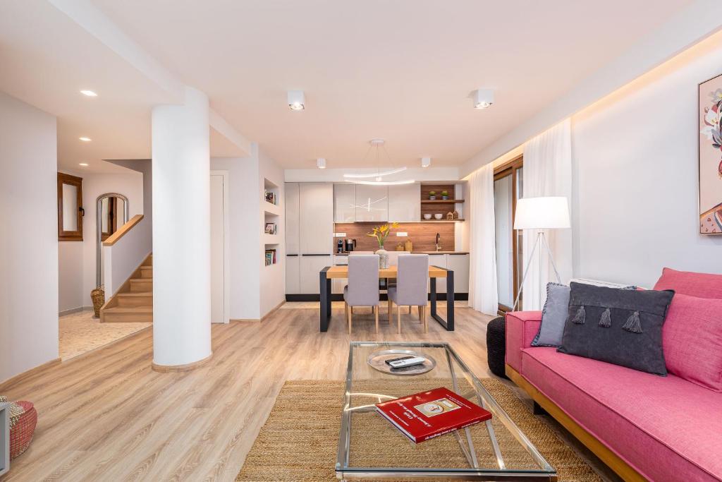 里亚帕德斯Lola's Luxury Apartments的客厅配有粉红色的沙发和桌子