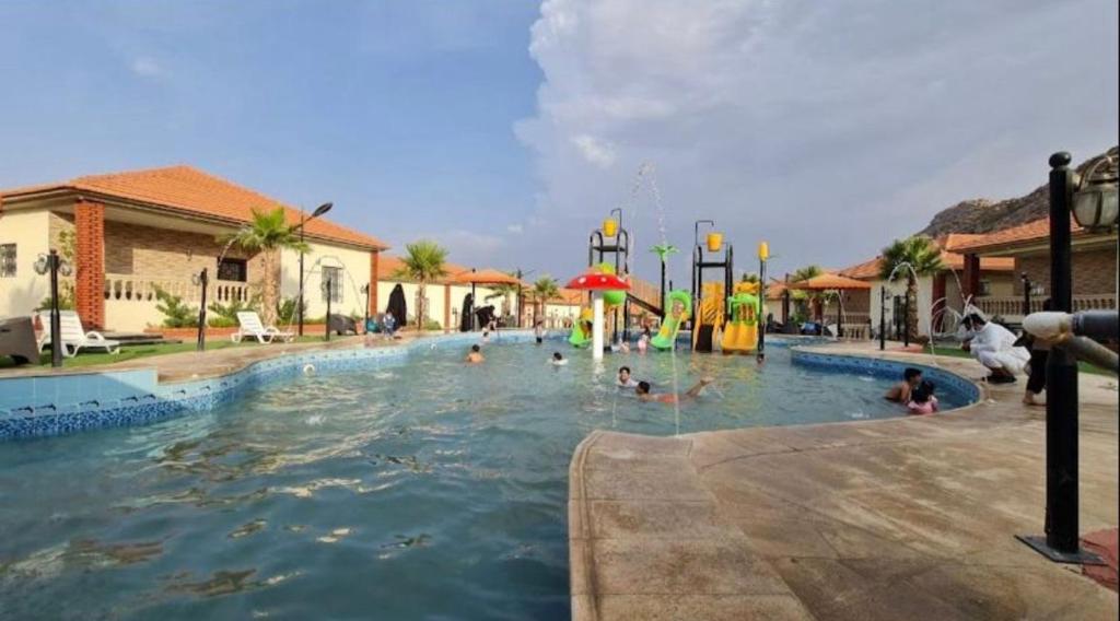 阿哈达منتجع الجزيرة الخضراء的一群人在水上公园的游泳池里