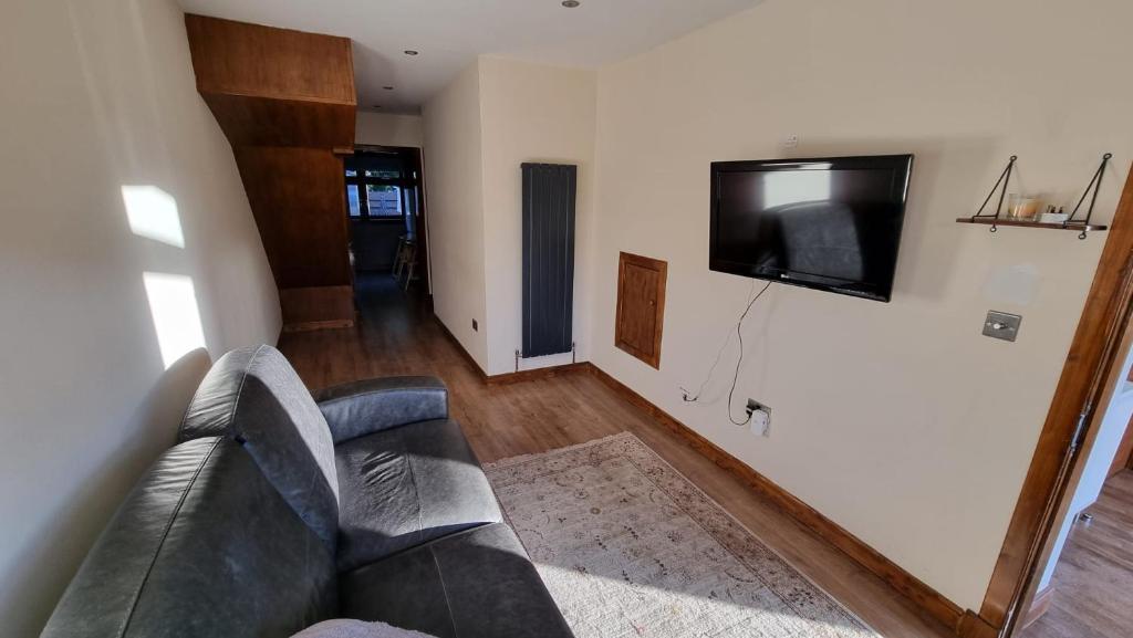 爱丁堡Self-catering extended family home的带沙发和平面电视的客厅