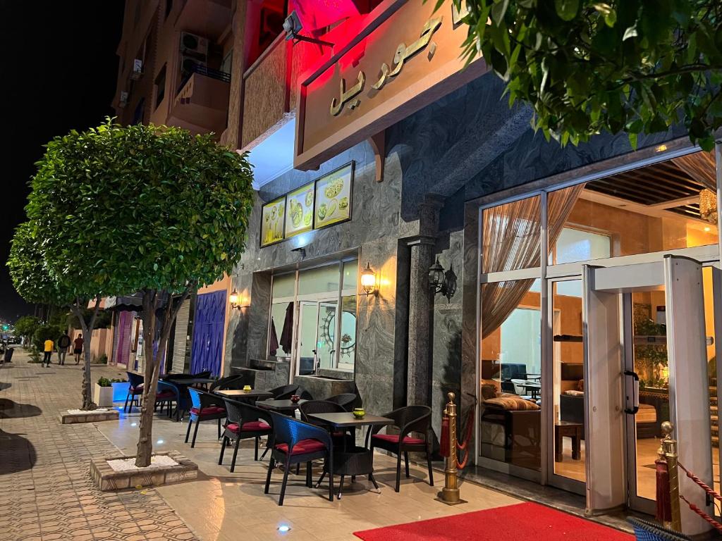 马拉喀什Hotel Majorelle的大楼外带桌椅的餐厅