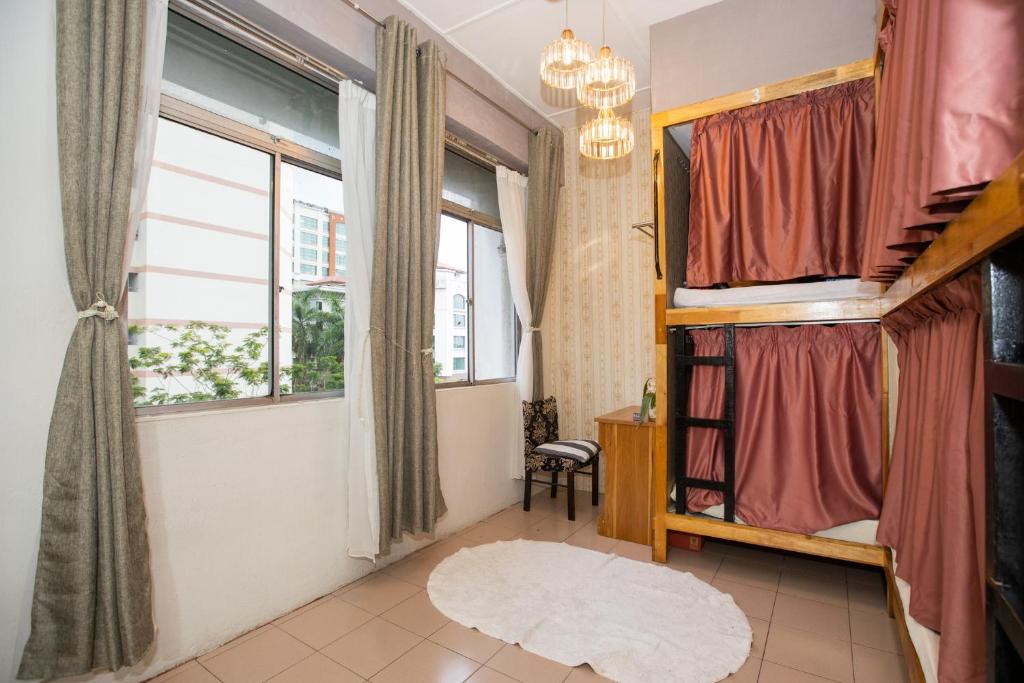 哥打京那巴鲁Escape Backpackers KK的客房设有一张床和两个窗户。