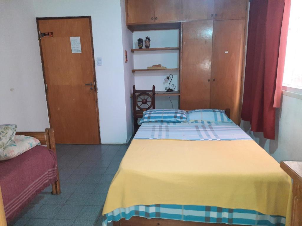 波萨达斯Monoambiente céntrico的一间卧室配有一张黄色毯子床