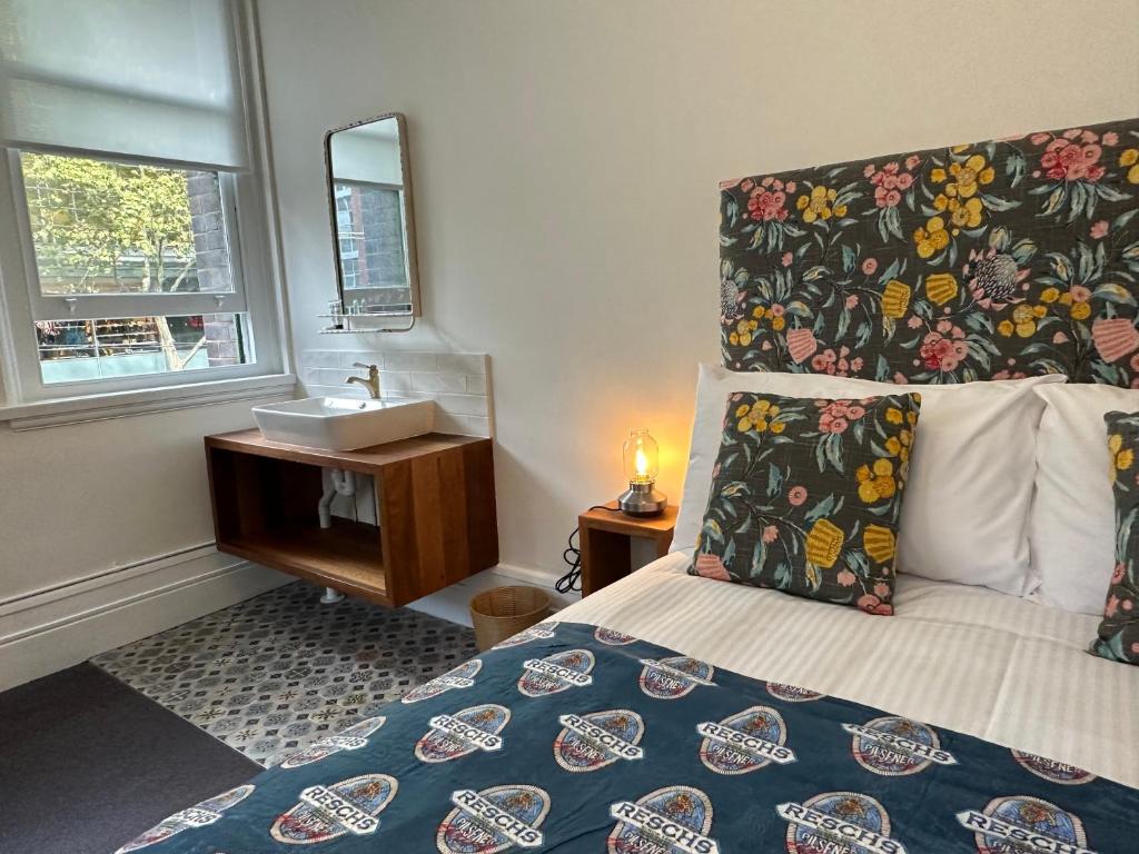 悉尼The Resch House的一间卧室配有床、水槽和镜子