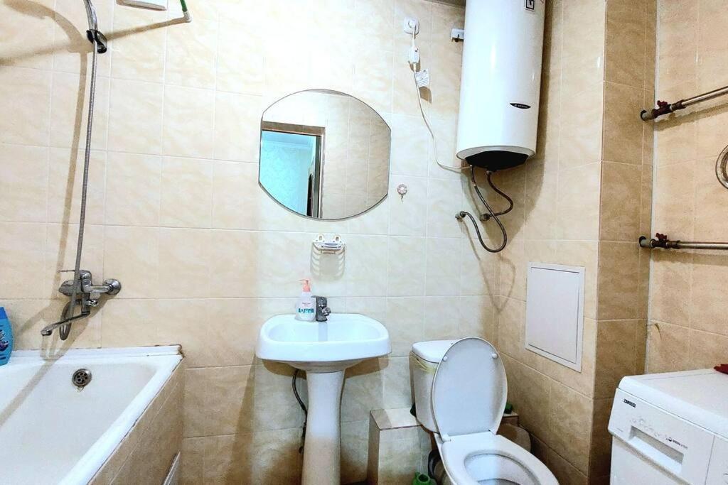 阿斯塔纳Аэропорт Астана 5 минут юг1的浴室配有盥洗池、卫生间和镜子。