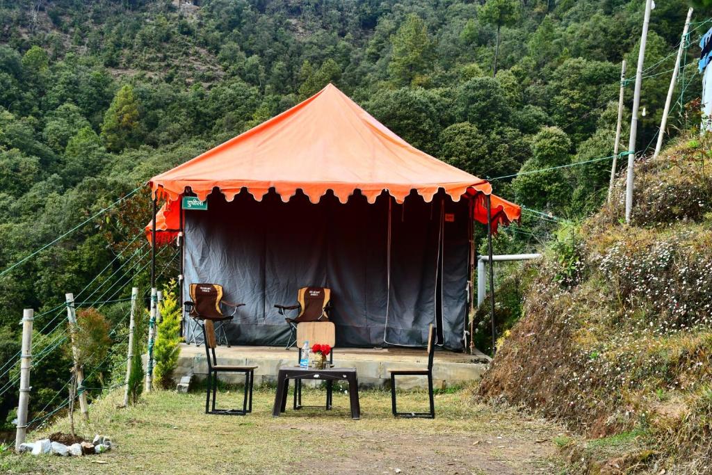 穆克缇斯瓦FOREST ACRES CAMPS的帐篷前配有2把椅子和1张桌子