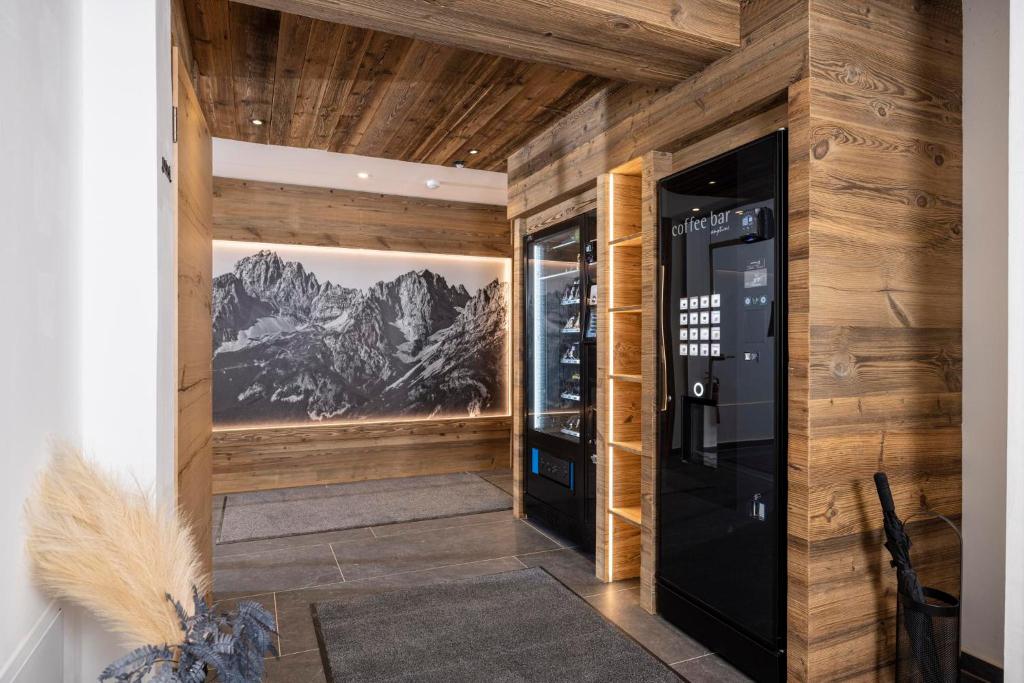 瑟尔Apartments Austria的一间设有木墙和黑色自动售货机的房间