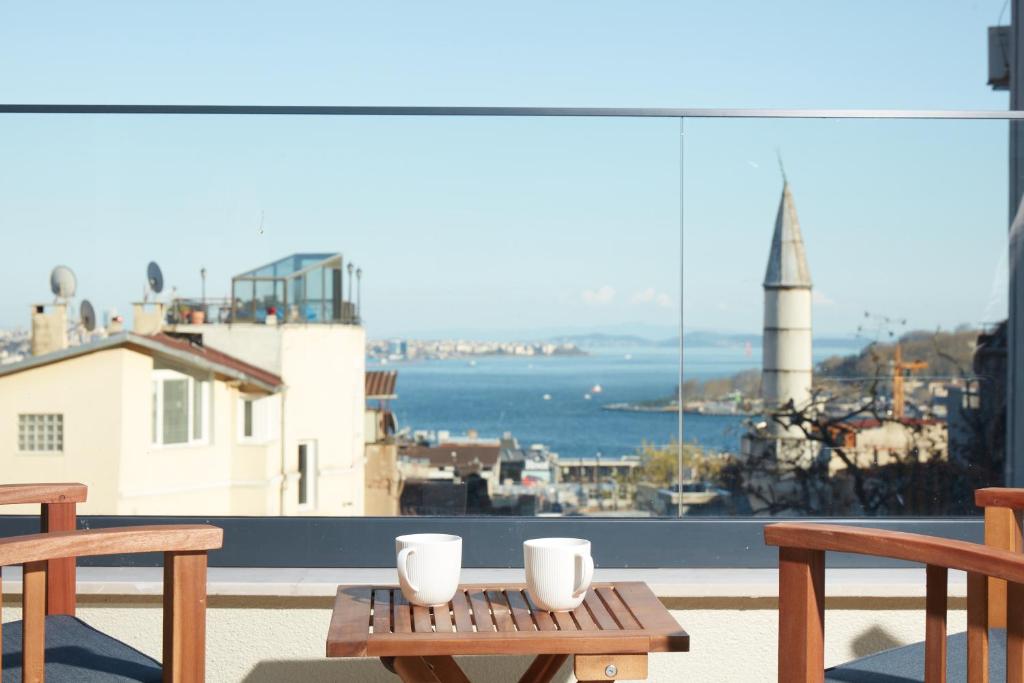 伊斯坦布尔CASA GALATA 35的一张桌子,上面有两杯,享有海景