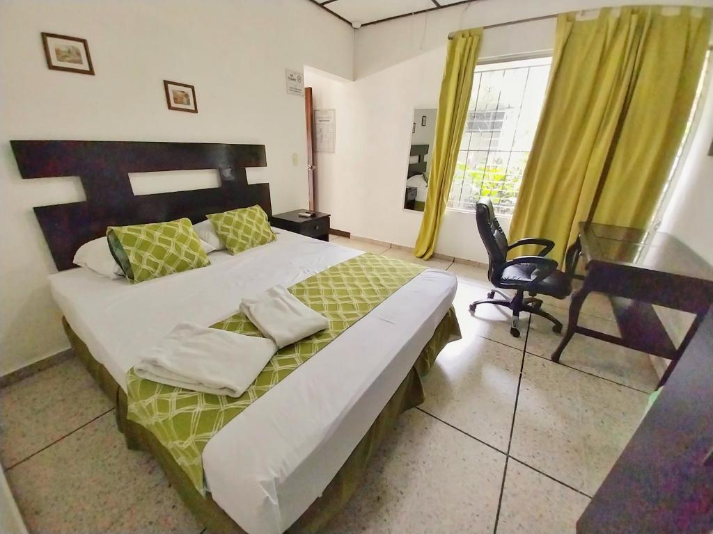 圣萨尔瓦多圣贝尼托-索娜罗莎套房及公寓的一间卧室配有一张床、一张书桌和一个窗户。