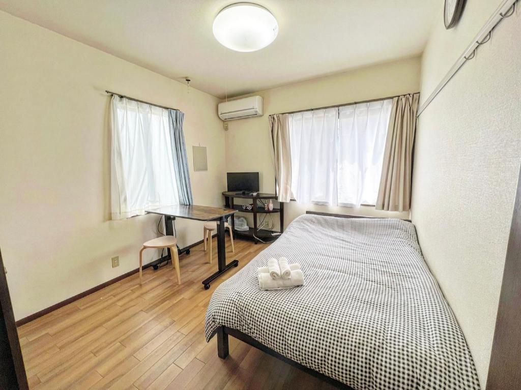 东京SHIBUYA HOUSE的一间卧室配有一张床和一张书桌