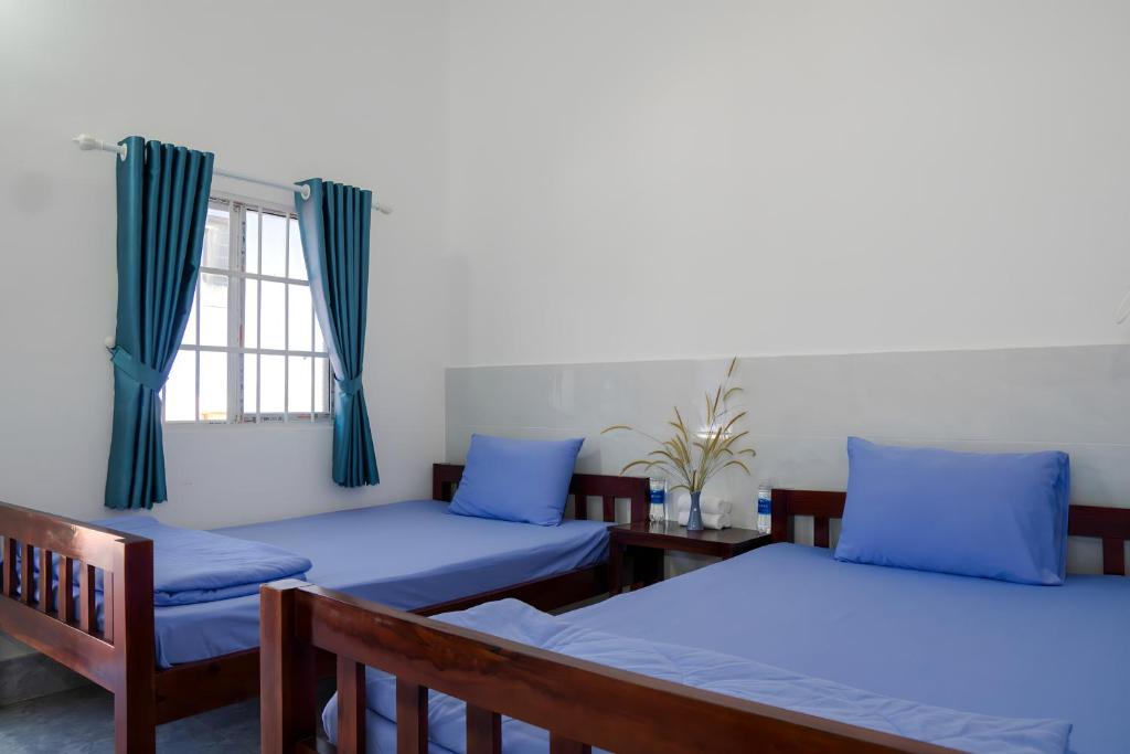 富国Lavender Garden Phu Quoc的客房设有两张床和窗户。