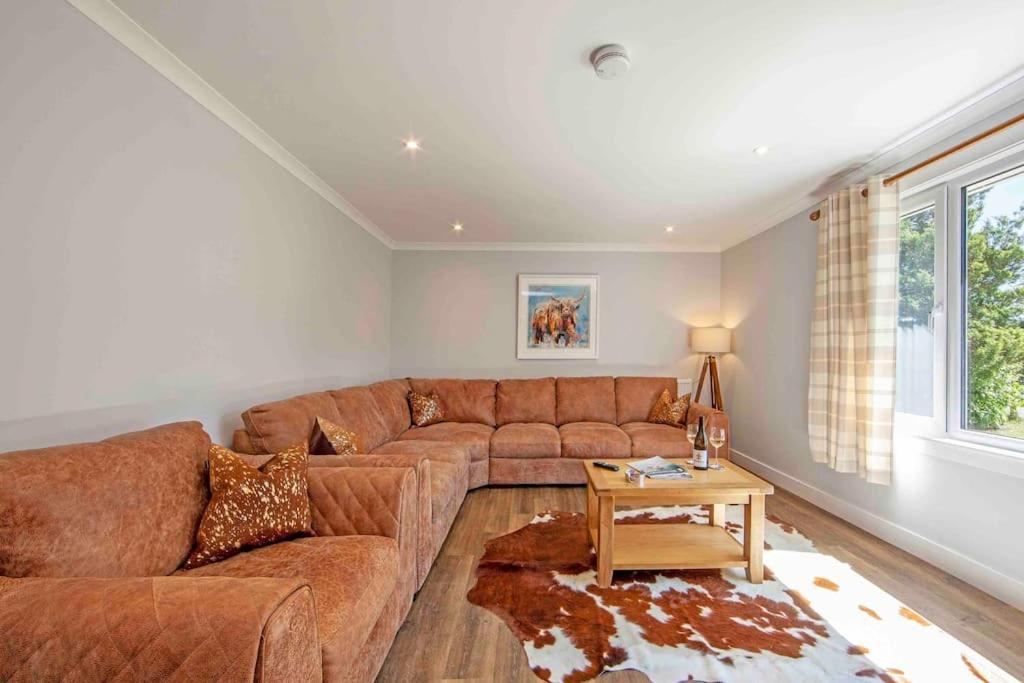 奥本Cuilreigh, North Connel的客厅配有棕色沙发和桌子