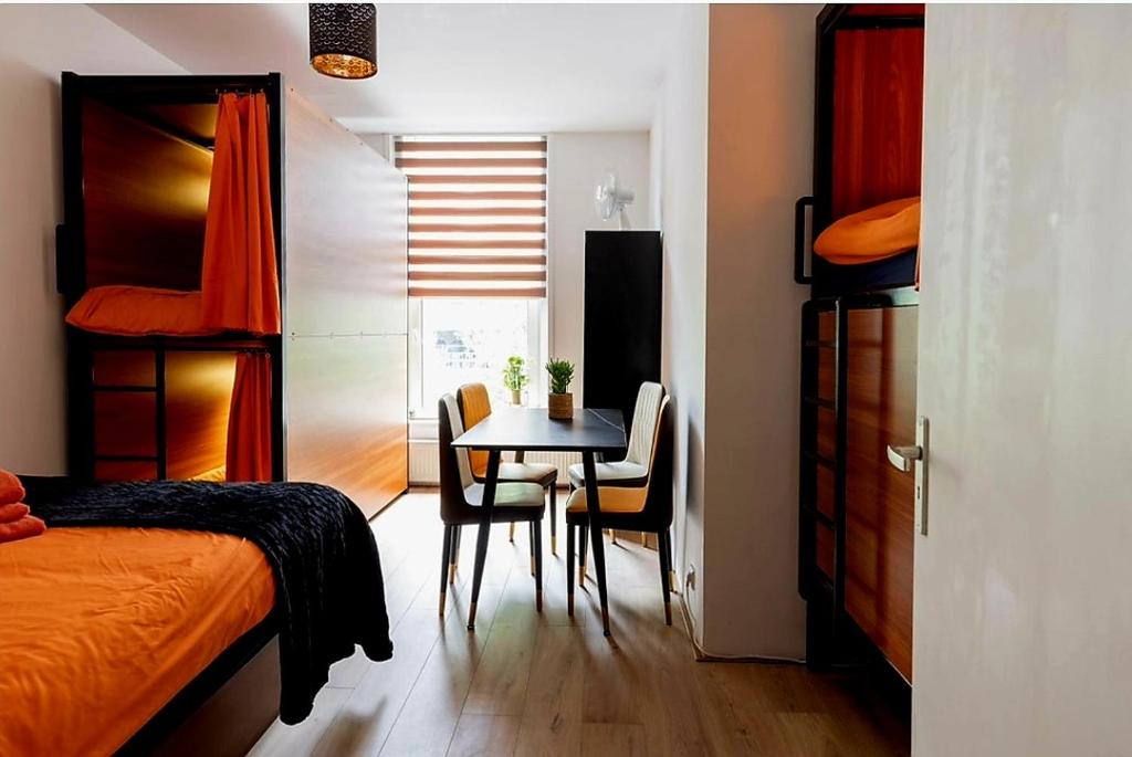 鹿特丹Recharge Hostel的一间卧室配有桌椅和一张床