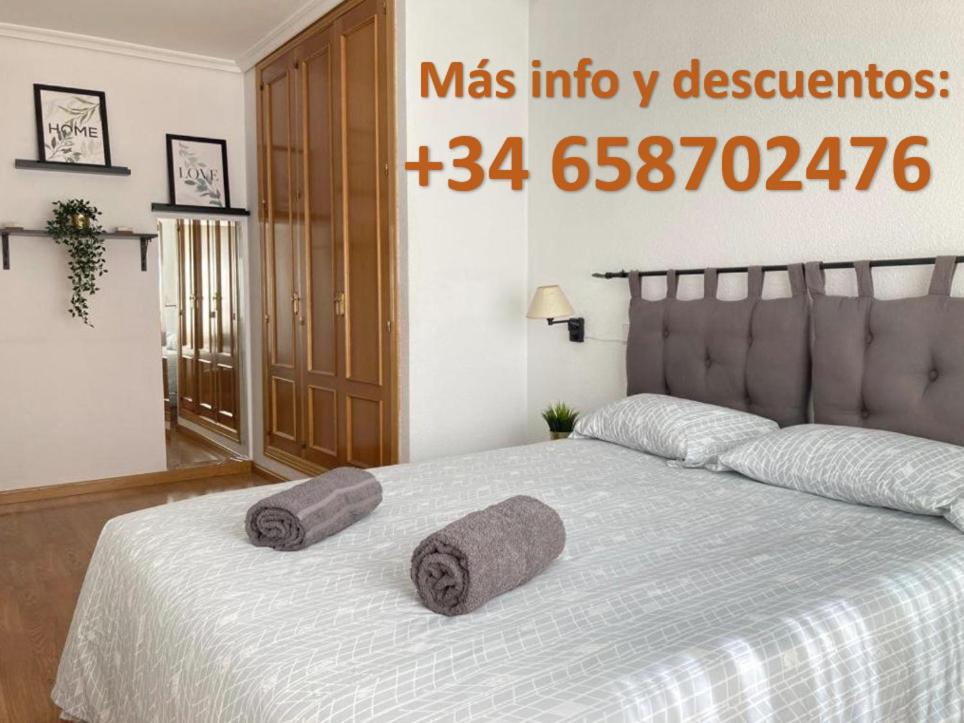 马德里Apartamento grande, 2 dormitorios, garaje gratis的一间卧室配有一张带两个枕头的床