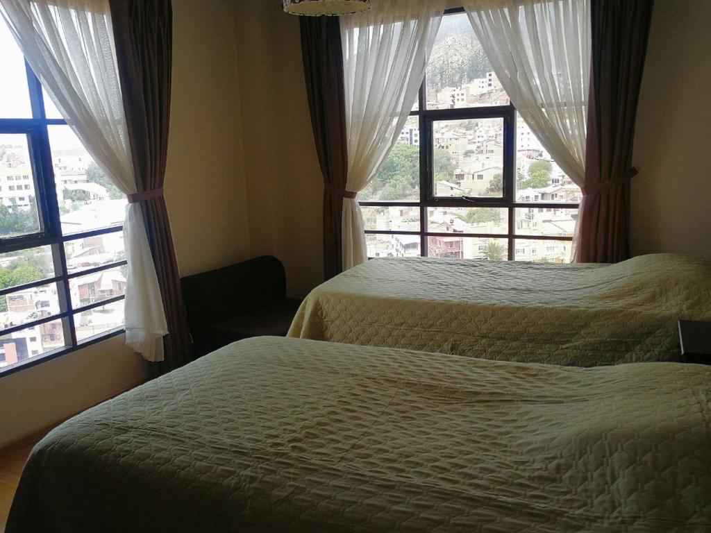 苏克雷Sucre Bellavista的带2扇窗户的客房内的2张床