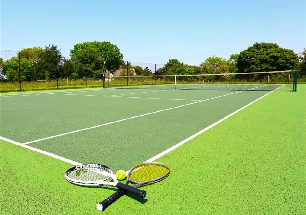 AldringhamWest Barn Cottage的网球场上的网球拍和球