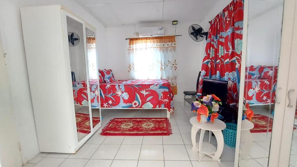 BelfastCharming 1-Bedroom House in St Thomas Jamaica的一间卧室配有一张床、一张桌子和一面镜子