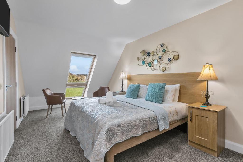 纽卡斯尔Tollyrose Country House的一间卧室配有一张带蓝色枕头的大床