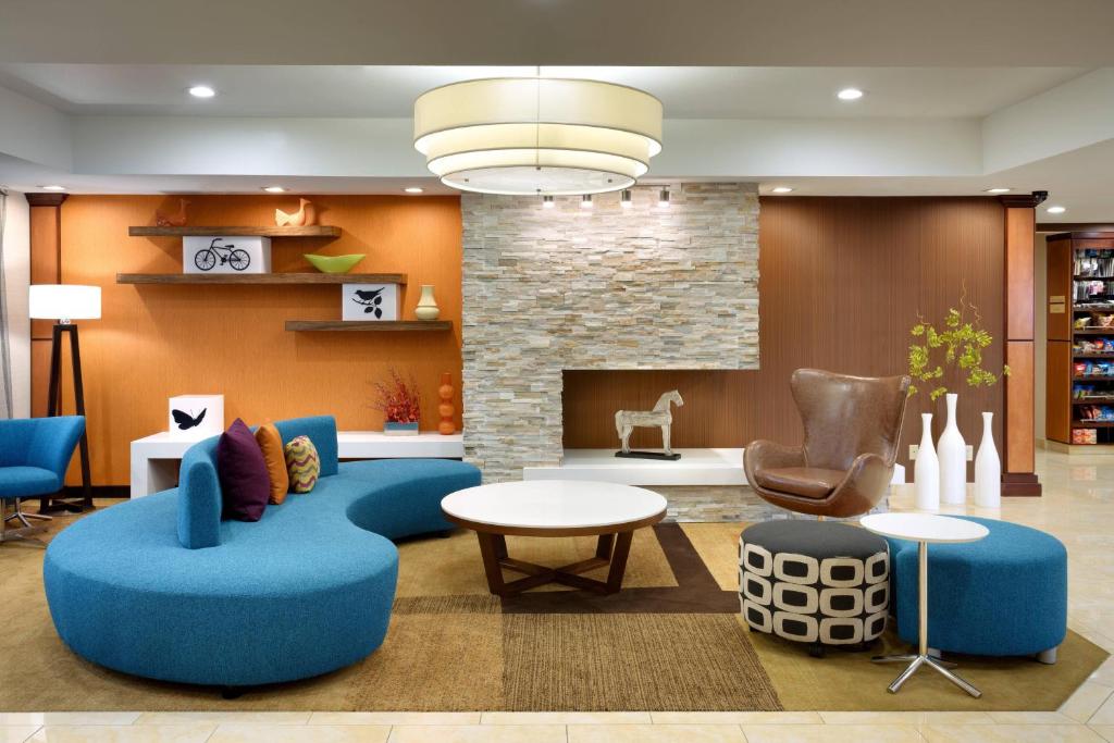 盐湖城盐湖城机场汉普顿套房酒店的客厅配有蓝色的家具和壁炉