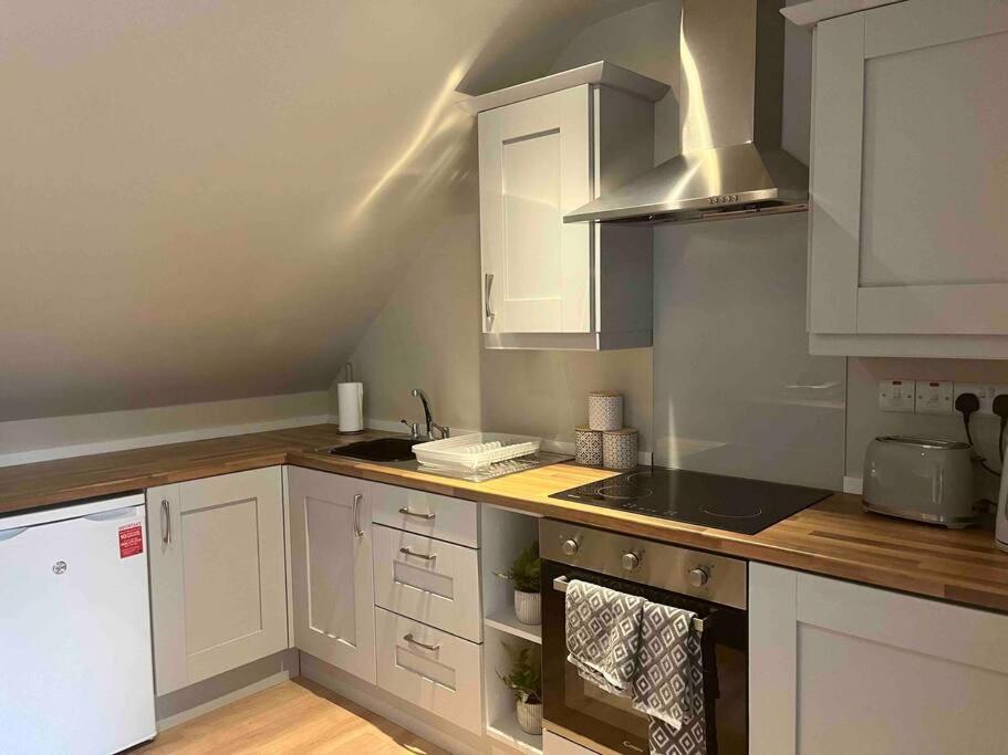 New FerryMid Antrim Modern Apartment的厨房配有白色橱柜和台面