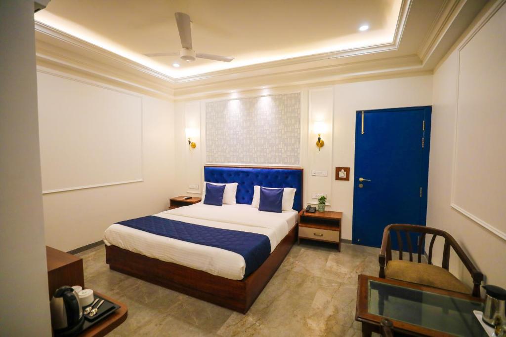 勒克瑙Hotel Ganga Maiya的一间卧室配有一张床和一个蓝色的门