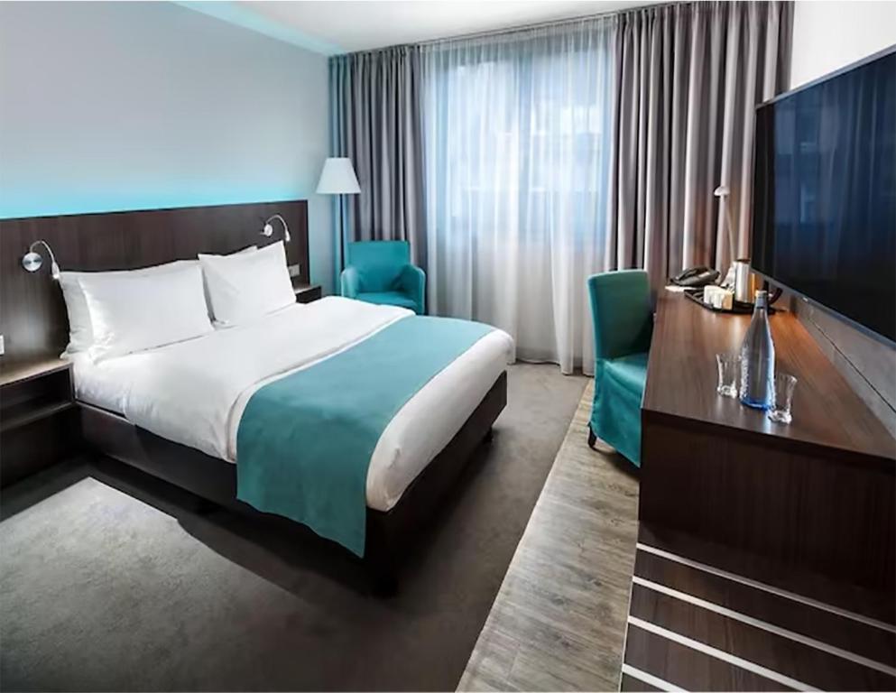 杜塞尔多夫Valemi Stay - Selfservice的配有一张床和一台平面电视的酒店客房