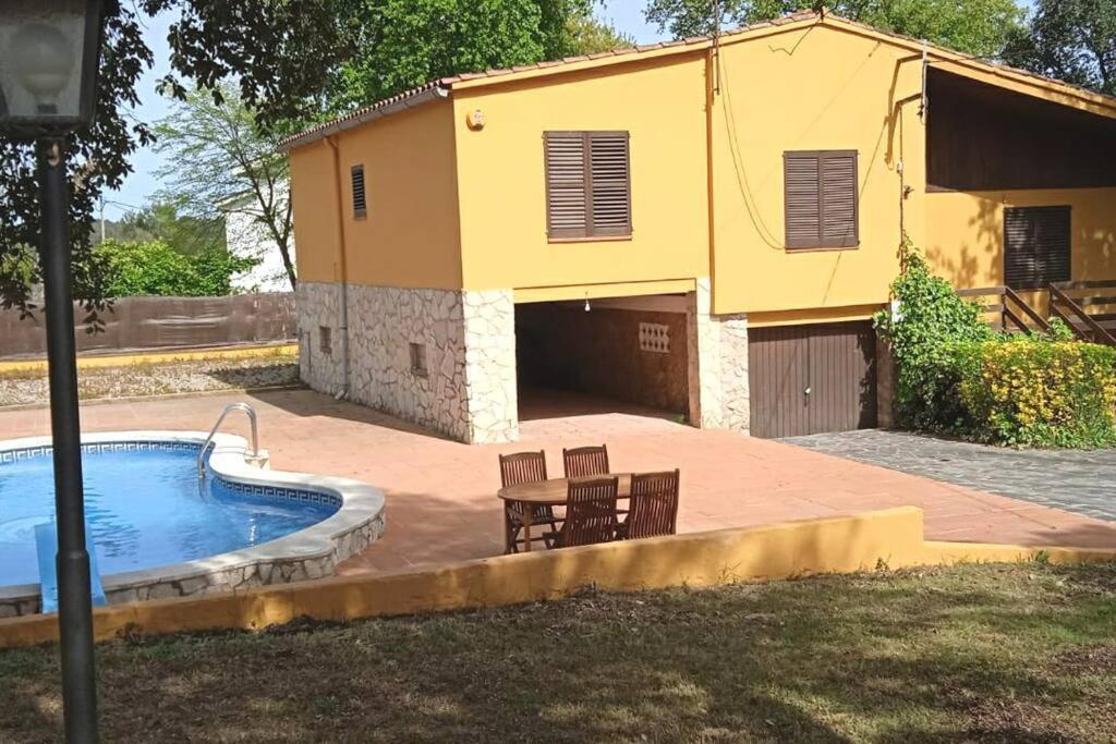 Casa independiente , piscina, naturaleza y relax的一座黄色的建筑,设有游泳池和房屋