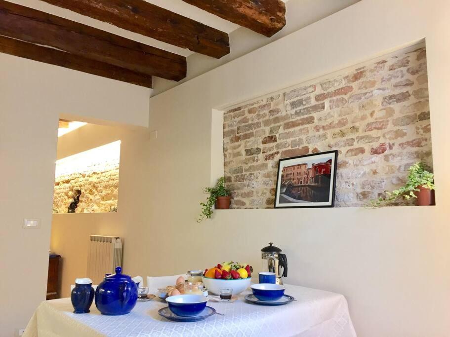 威尼斯Ca' Spendore del Sole的上面有蓝色花瓶的白色桌子