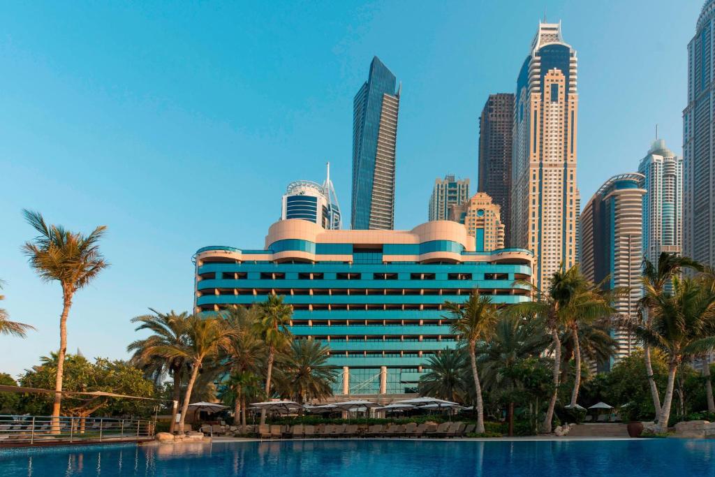 迪拜Le Meridien Mina Seyahi Beach Resort & Waterpark的一座城市前方棕榈树酒店